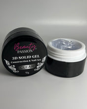 Charger l'image dans la galerie, Pot de Solid Gel 3D Clear de Beauty Passion, gel de construction transparent ultra dense pour nail art en relief et extensions d'ongles. Texture solide modelable à la main pour création de motifs 3D et effets chromés.