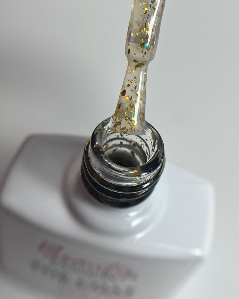 Flacon de Top Coat Gold Flakes 10ml Beauty Passion, finition brillante avec incrustations de feuilles d'or pour un effet luxe.